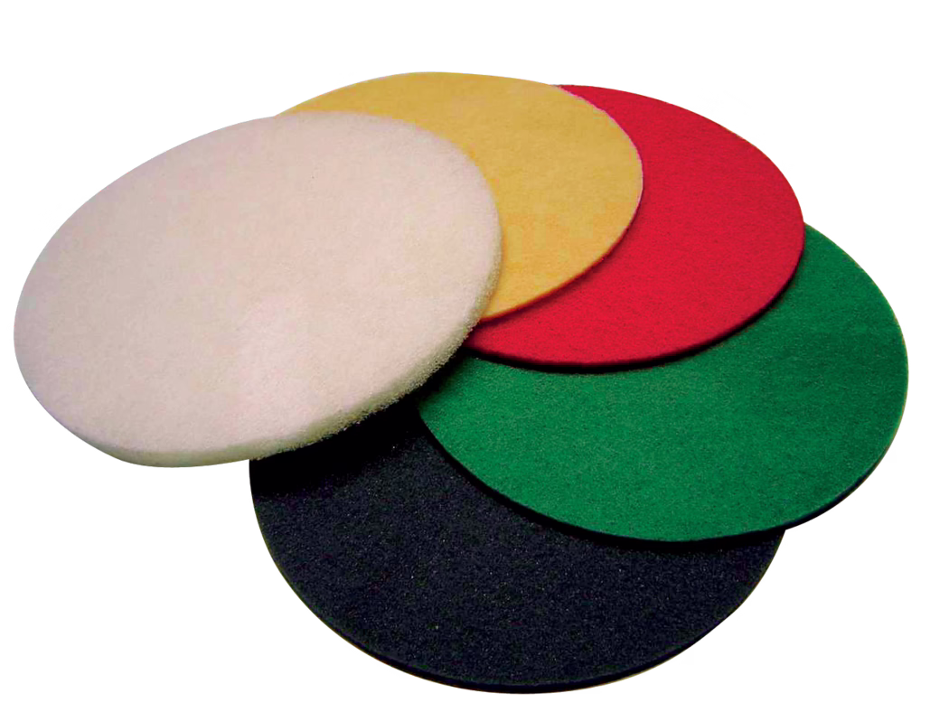 Close-up of five circular floor-polishing pads in a stacked, slightly overlapping arrangement on a white background. The pads are made of fibrous abrasive or buffing material and have uniform thickness and rounded edges; visible colors from top to bottom are white, yellow, red, green and black. The image emphasizes texture and color contrast and suggests use with rotary floor machines for cleaning, scrubbing, polishing or finishing hard floors.